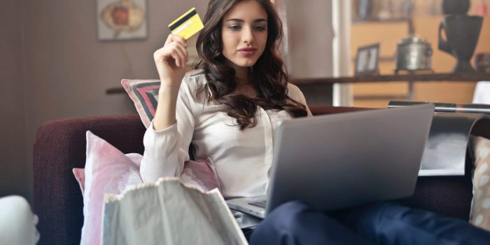 Young Adult woman using her credit card to shop online